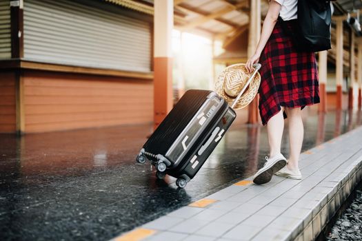 summer, relax, vacation, travel, portrait of cute Asian girl showing smile and showing joy while waiting at the train station for a summer trip