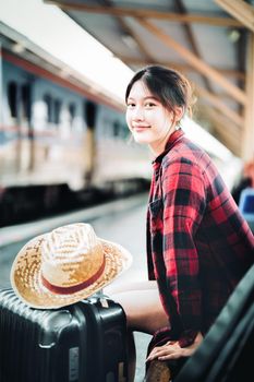 summer, relax, vacation, travel, portrait of cute Asian girl showing smile and waiting at the train station for a summer trip