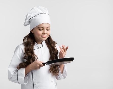 front view curly hair young girl holding cooking pan