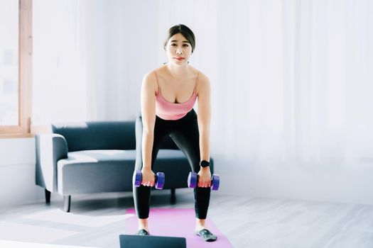 stress relief, , breathing exercises, meditation, portrait of Asian healthy woman lifting weights to strengthen her muscles after work