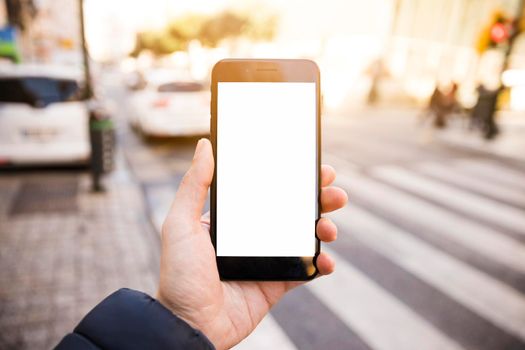 close up man s hand showing mobile phone with white screen display road