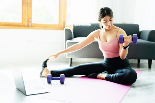 stress relief, muscle relaxation, breathing exercises, exercise, meditation, portrait of Young Asian woman relaxing her body from office work by practicing yoga by watching online tutorials