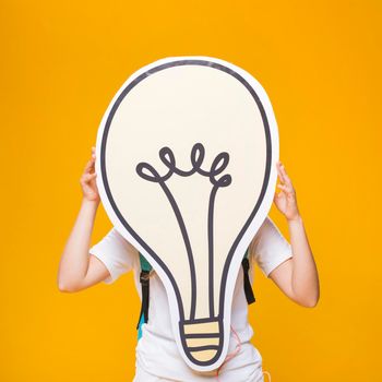 portrait schoolgirl with big light bulb