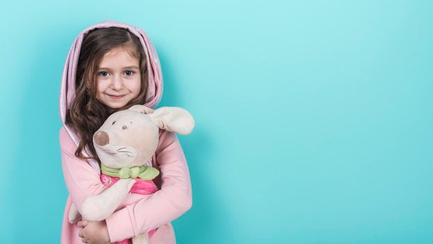 little girl standing with toy bunny