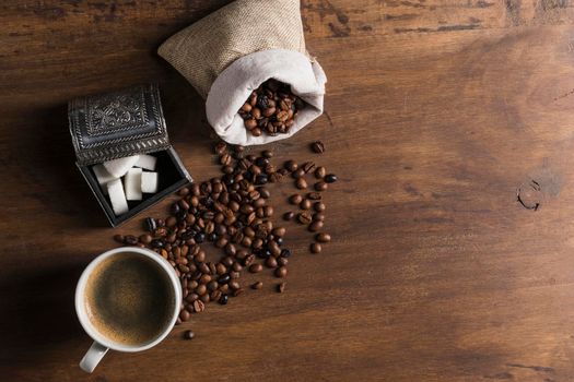 sack with coffee beans near box sugar cup