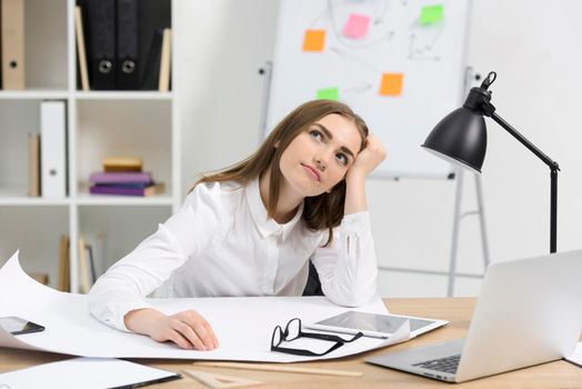 contemplated young businesswoman with white paper eyeglasses digital tablet wooden desk