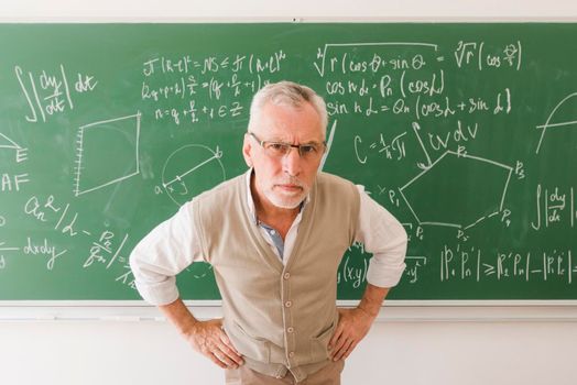 serious aged professor lecture room looking camera