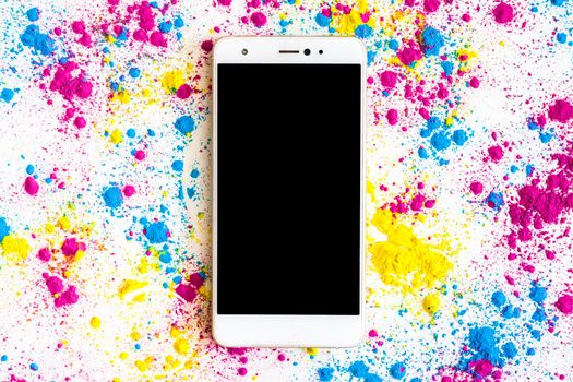 holi color powder around smartphone with black screen display