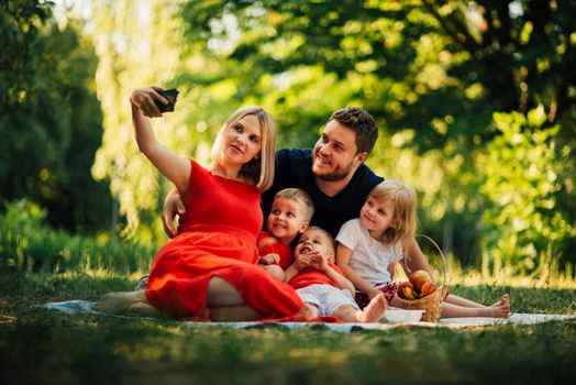 mother taking family selfie outdoors