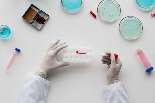 close up scientist holding pipette