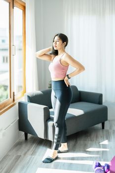 stress relief, muscle relaxation, breathing exercises, exercise, meditation, portrait of Young Asian woman relaxing her body from office work by practicing yoga by watching online tutorials