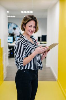 laughing woman holding tablet office