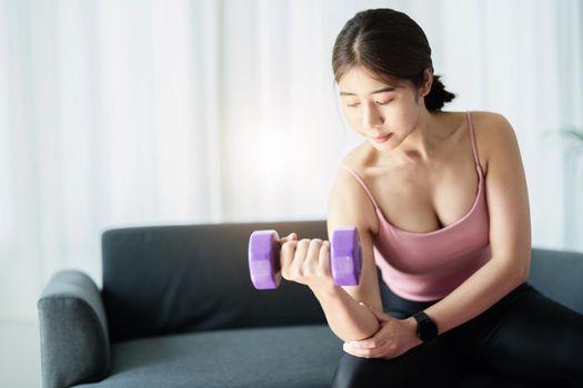 stress relief, , breathing exercises, meditation, portrait of Asian healthy woman lifting weights to strengthen her muscles after work