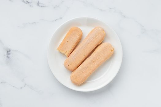 Italian cookie savoiardi. Sweet biscuits. Sponge cookies tiramisu isolated on white background. Copy Space
