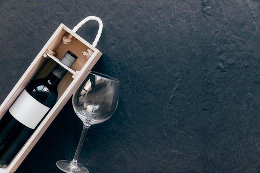 empty glass near box with wine