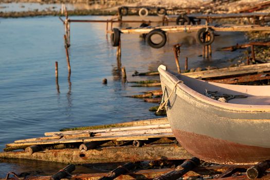 The tranquil afternoon on a seashore with a piers and boat