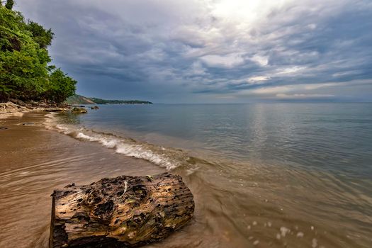 Seascape, Superb long exposure sunrise view with a log at the Black Sea coast, Bulgaria