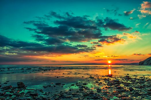 Magnificent sunset view at the Black sea coast, Bulgaria.Sea rocks at colorful sunset.