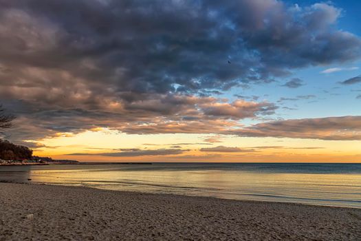 Beautiful colorful clouds over the sea. Amazing sky after sunset.