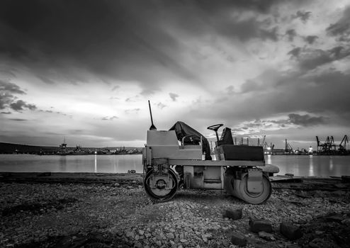 Beautiful black and white view at small roller at a construction site in a beautiful twilight