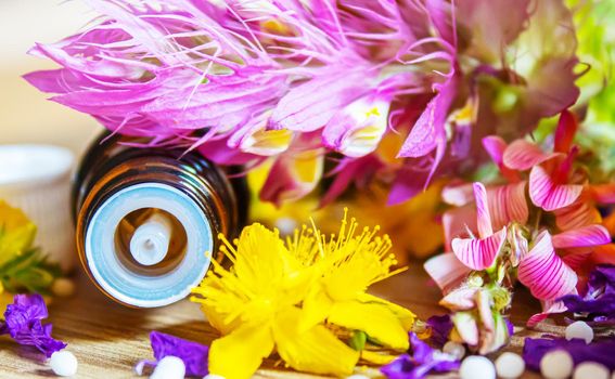 medicinal herbs, oils in small bottles homeopathy. selective focus.nature