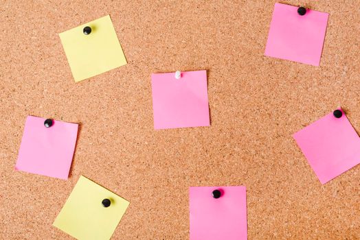 close up corkboard with various note papers