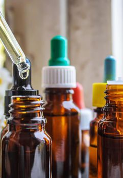 Medicinal herbs in bottles. chamomile oil extract. Selective focus. Nature.