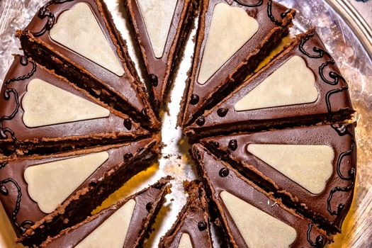 Delicious chocolate Sacher cake, cutting to the pieces. Top view