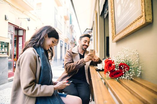 couple browsing smartphones date