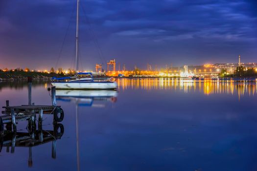 amazing view from a pier to yacht and city lights water reflection 