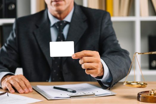 close up lawyer showing white blank card with contract table