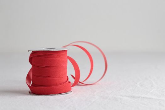 Red velvet decorative ribbon skein on white background