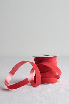 Red velvet decorative ribbon skein on white background