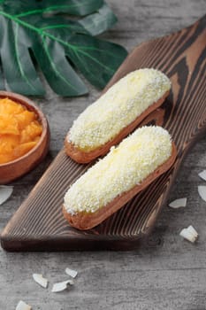 Traditional French dessert sweet eclairs on a gray background