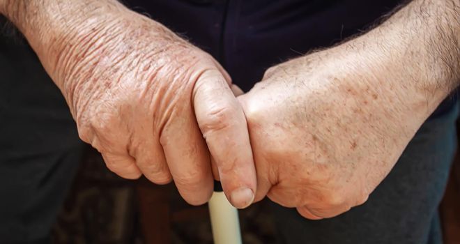 old people holding each hand. selective focus.people