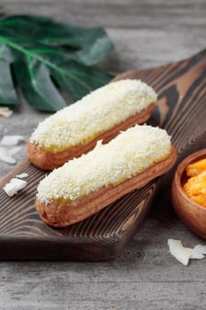 Traditional French dessert sweet eclairs on a gray background