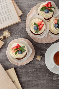 Anna Pavlova cake with cream and fresh strawberries on a dark background