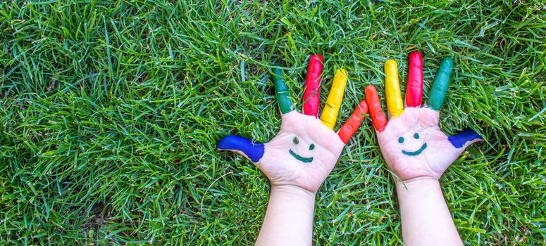 Children's hands in the colors of summer. Selective focus.nature