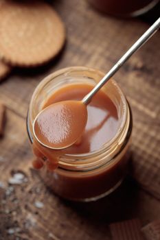 Salted Caramel in a jar on a wooden table