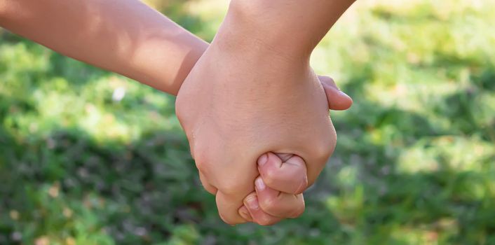 mom holding baby by the hand. selective focus.people