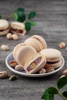 Sweet dessert - Macaroons with pistachios on a gray background