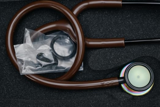 Medical stethoscope. Brown medical stethoscope.The concept of healthcare.Stethoscope on a dark background