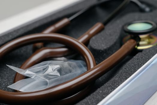 Medical stethoscope. Brown medical stethoscope.The concept of healthcare.Stethoscope on a dark background