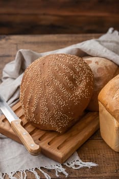loaf of bread on wooden background, food closeup