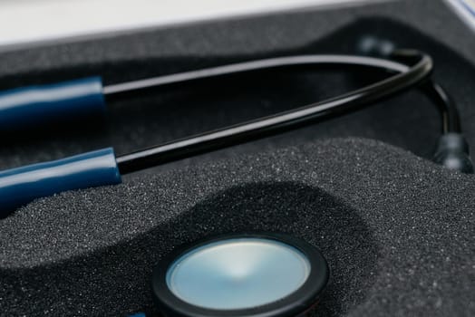 Medical stethoscope. Blue medical stethoscope.The concept of healthcare.Stethoscope on a dark background