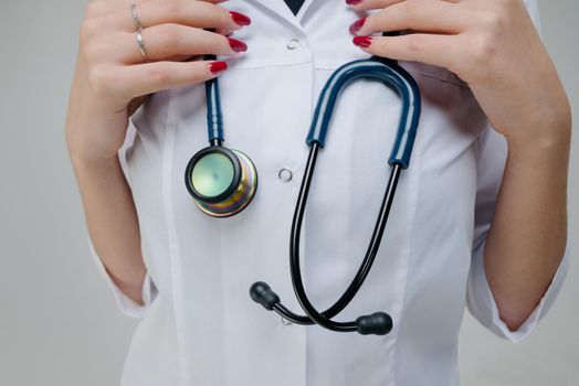 Blue medical stethoscope.A doctor with a stethoscope.A doctor holding a stethoscope.The concept of healthcare.