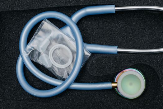 Medical stethoscope. Blue medical stethoscope.The concept of healthcare.Stethoscope on a dark background