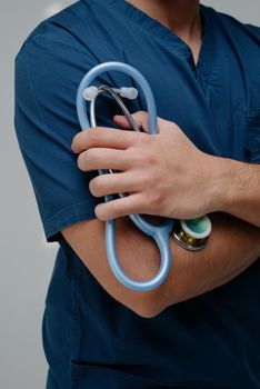 Blue medical stethoscope.A doctor with a stethoscope.A doctor holding a stethoscope.The concept of healthcare.