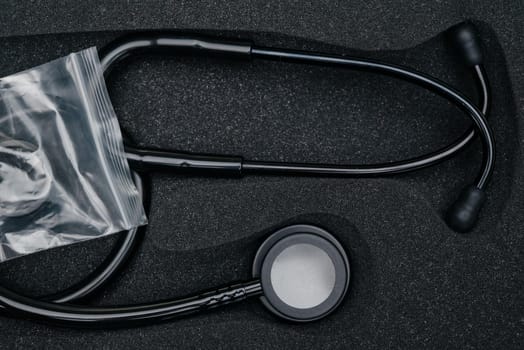 Medical stethoscope. Black medical stethoscope.The concept of healthcare.Stethoscope on a dark background