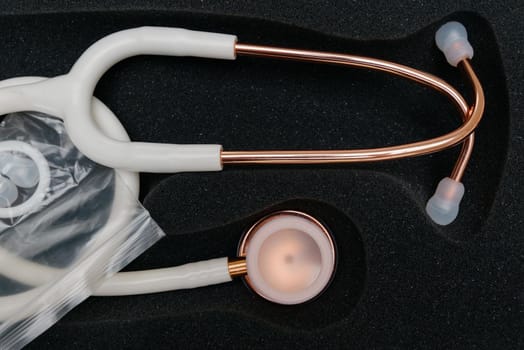 Medical stethoscope. White medical stethoscope.The concept of healthcare.Stethoscope on a dark background